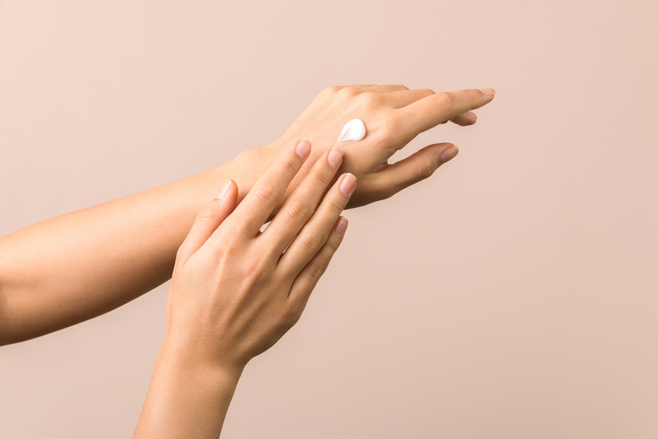 Woman gently cleansing her face to protect the skin barrier in summer